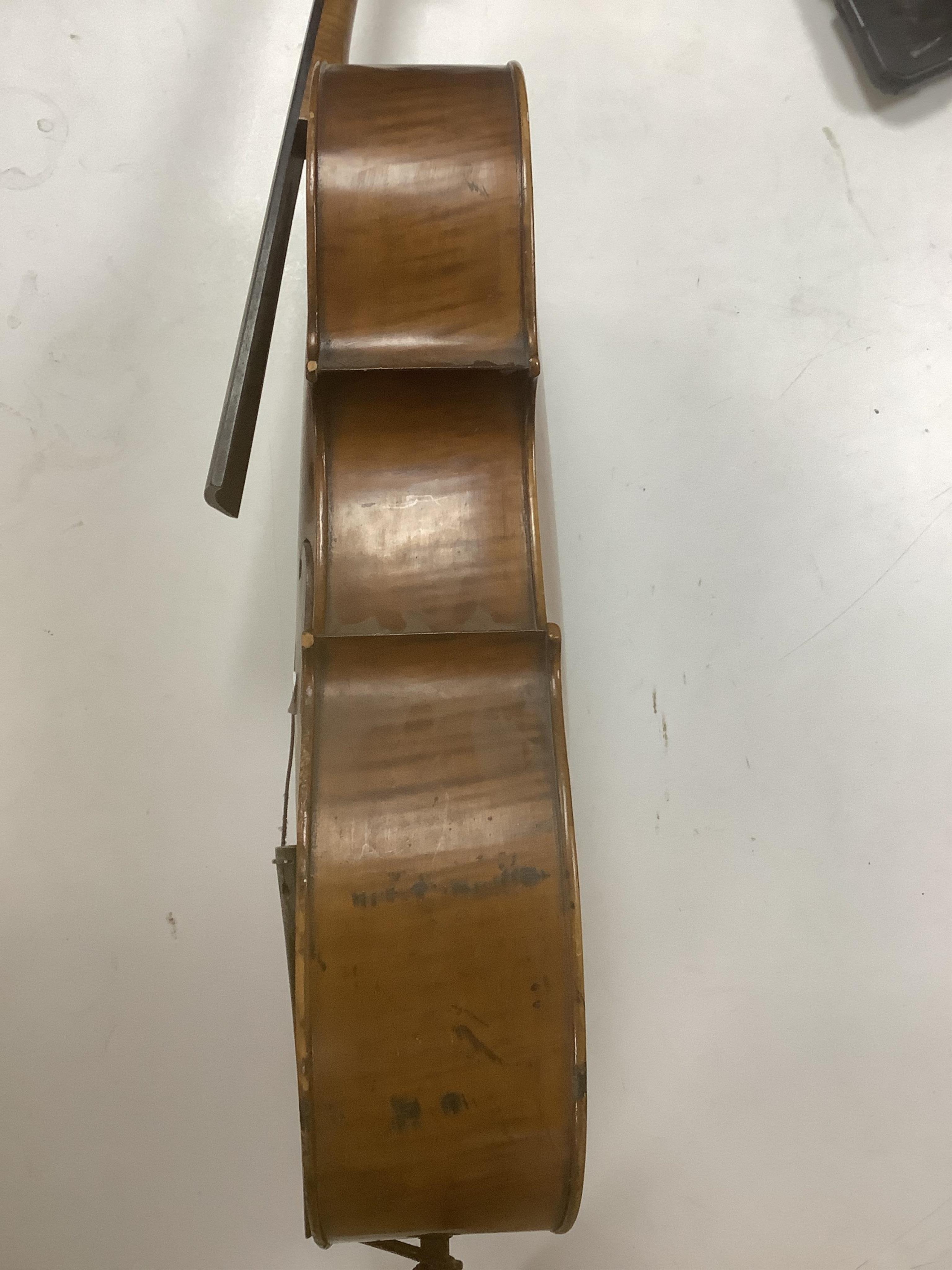 A late 19th century small cello, unsigned and without label inside body, stamped inventory number 769, length of back 62cm. Condition - poor to fair